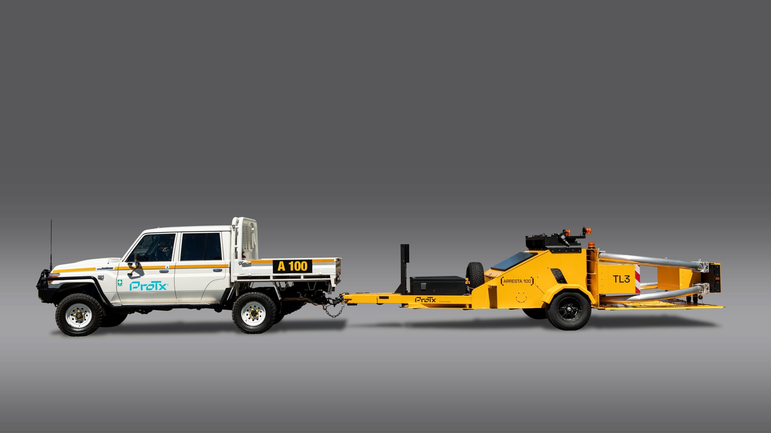 A white Profix utility truck is connected to a large yellow trailer labeled TL3 with various mechanical equipment mounted on it, both set against a plain gray background.